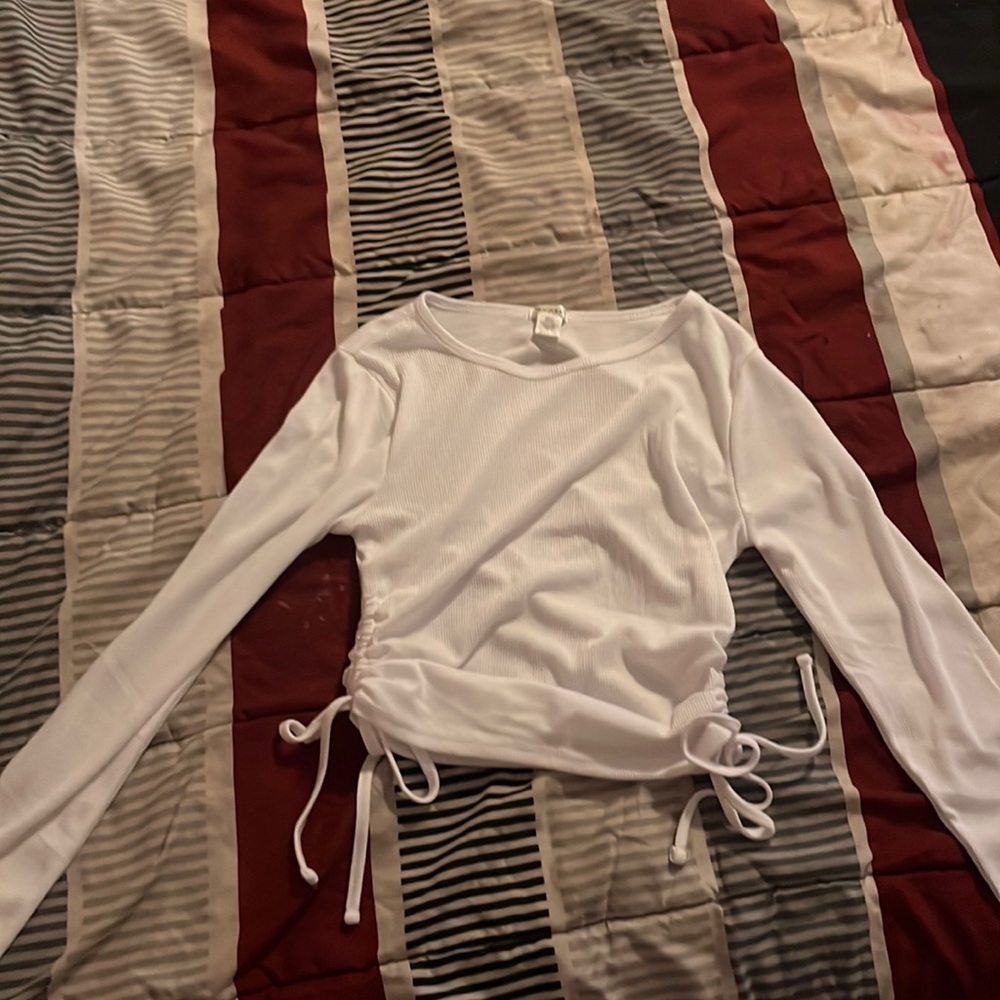 A small, white long sleeve bozzolo shirt